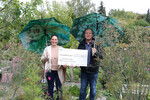 Armin Knauer, Präsidiumsmitglied im Verband Garten-, Landschafts- und Sportplatzbau Bayern, bei der Übergabe des symbolischen Schecks an Judith Korndörfer, Gewinnerin des Videowettbewerb „Unsere grüne Straße lebt!“.